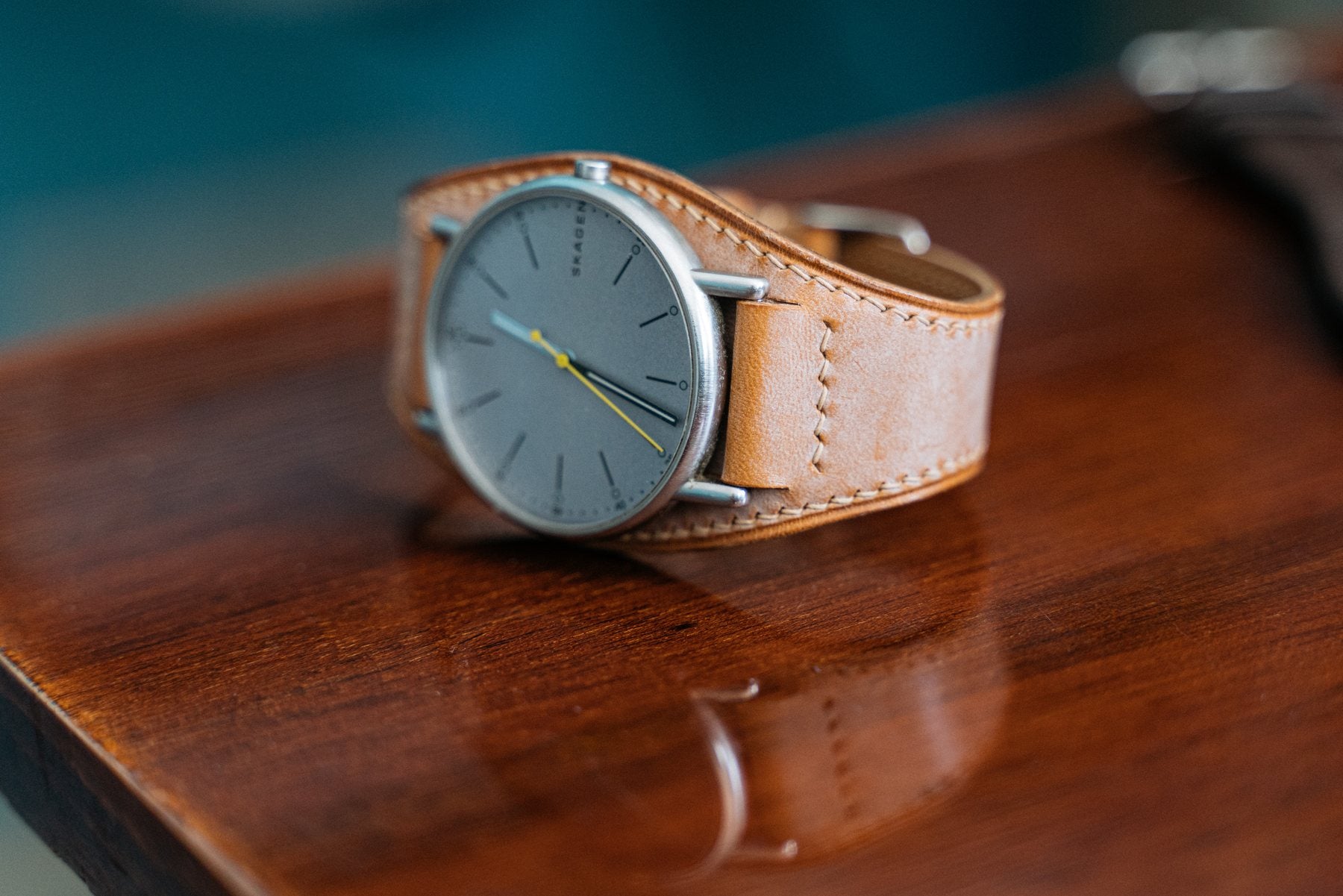 A classic hand-stitched strap on a minimal watch